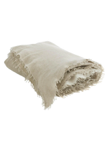 Fringed cashmere throw in Sand
