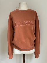 a comfy easy to wear sweatshirt in wam terracotta with 'vintage' embroidered upside down for an abstract look