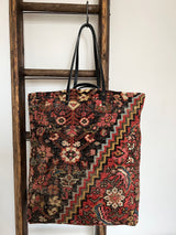 an overnight tote bag with vintage mahal rug and mustard suede leather