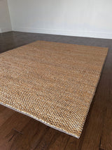 a chunky braided jute rug with ombre caramel tones