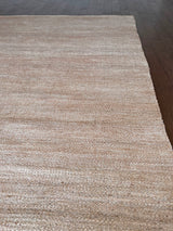 a hand braided jute rug in natural undyed sisal
