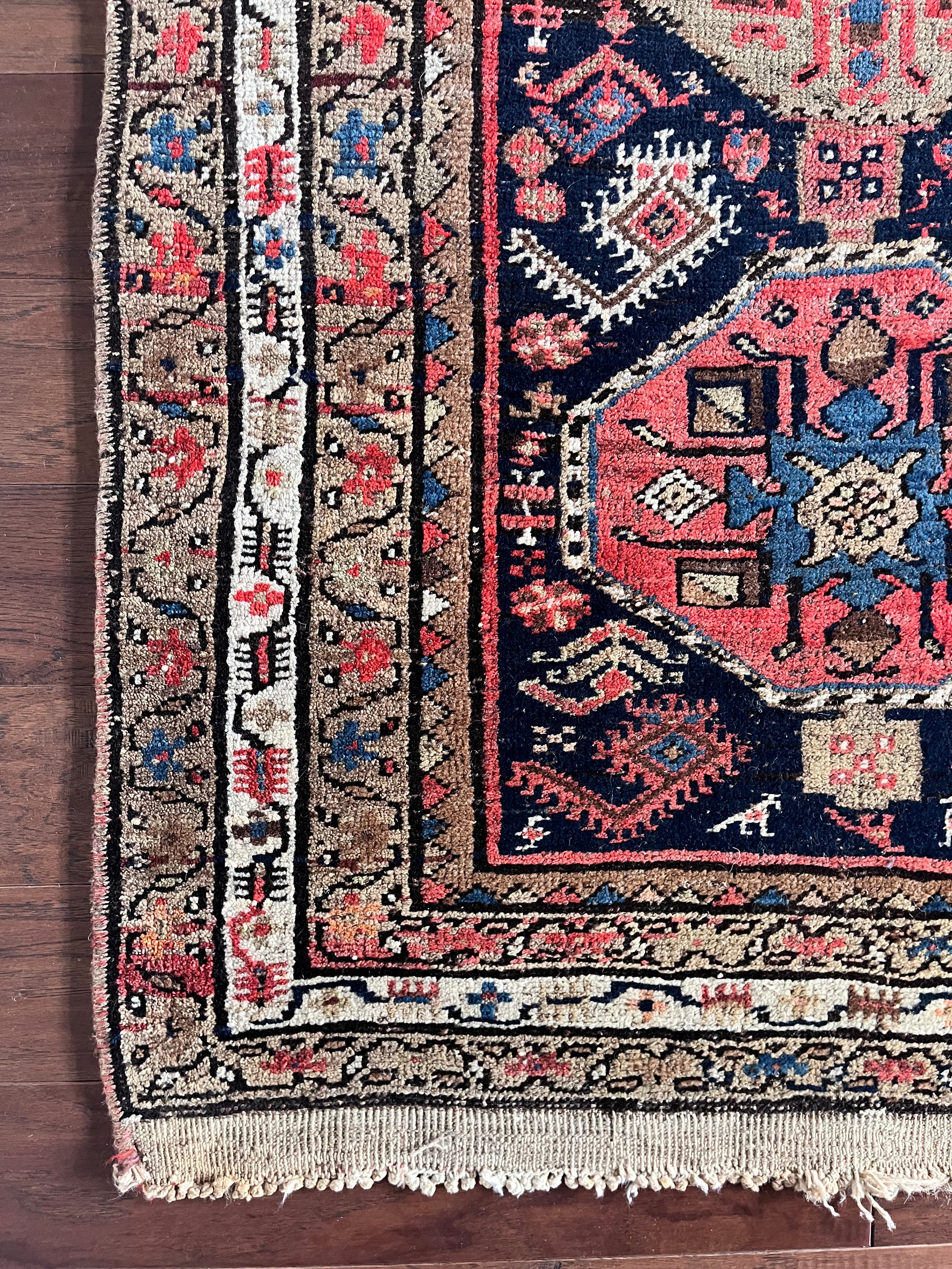 a mini north west persian runner with a dark blue field and neon pink accents