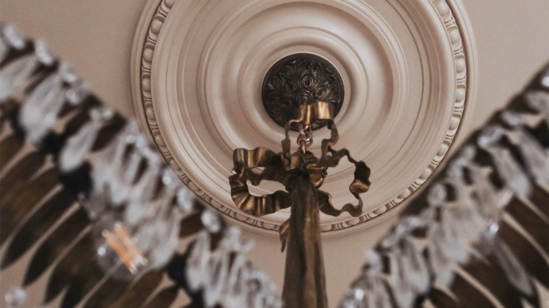 A close up of an antique Josef Hoffman chandelier in an ornate ceiling rose