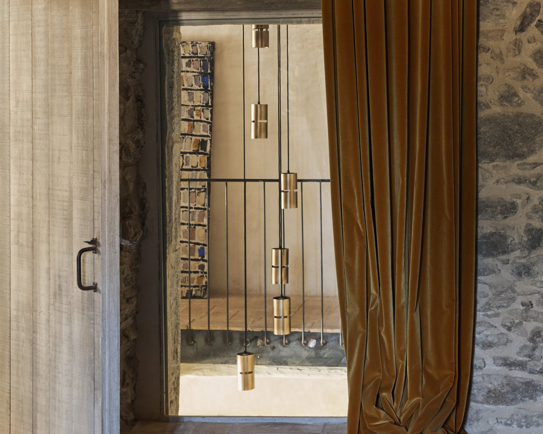 exposed stone wall with mustard velvet drape