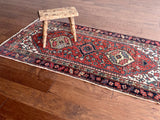 an antique heriz rug with a coral field and pretty blue accents