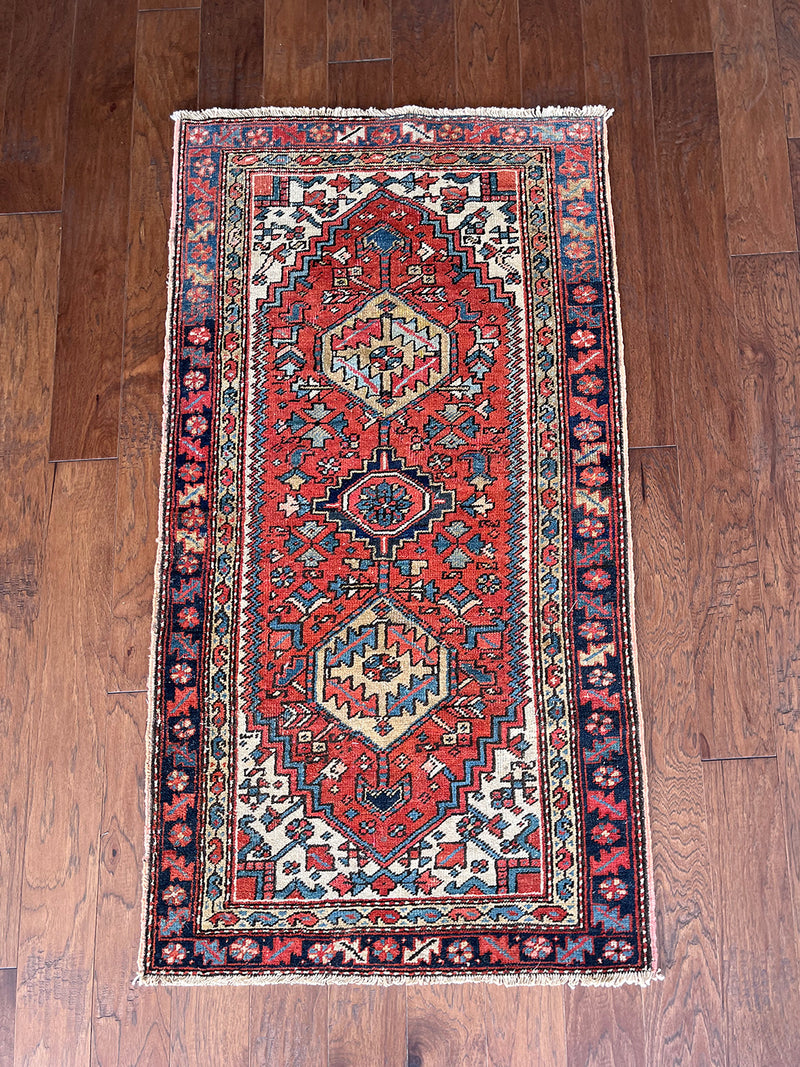 an antique heriz rug with a coral field and pretty blue accents