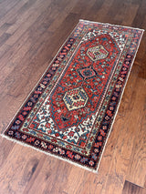an antique heriz rug with a coral field and pretty blue accents