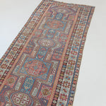 Decorative rug with intricate patterns on a white floor