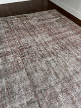 a large antique tabriz rug with a pared back crimson field and faded blue and green accents