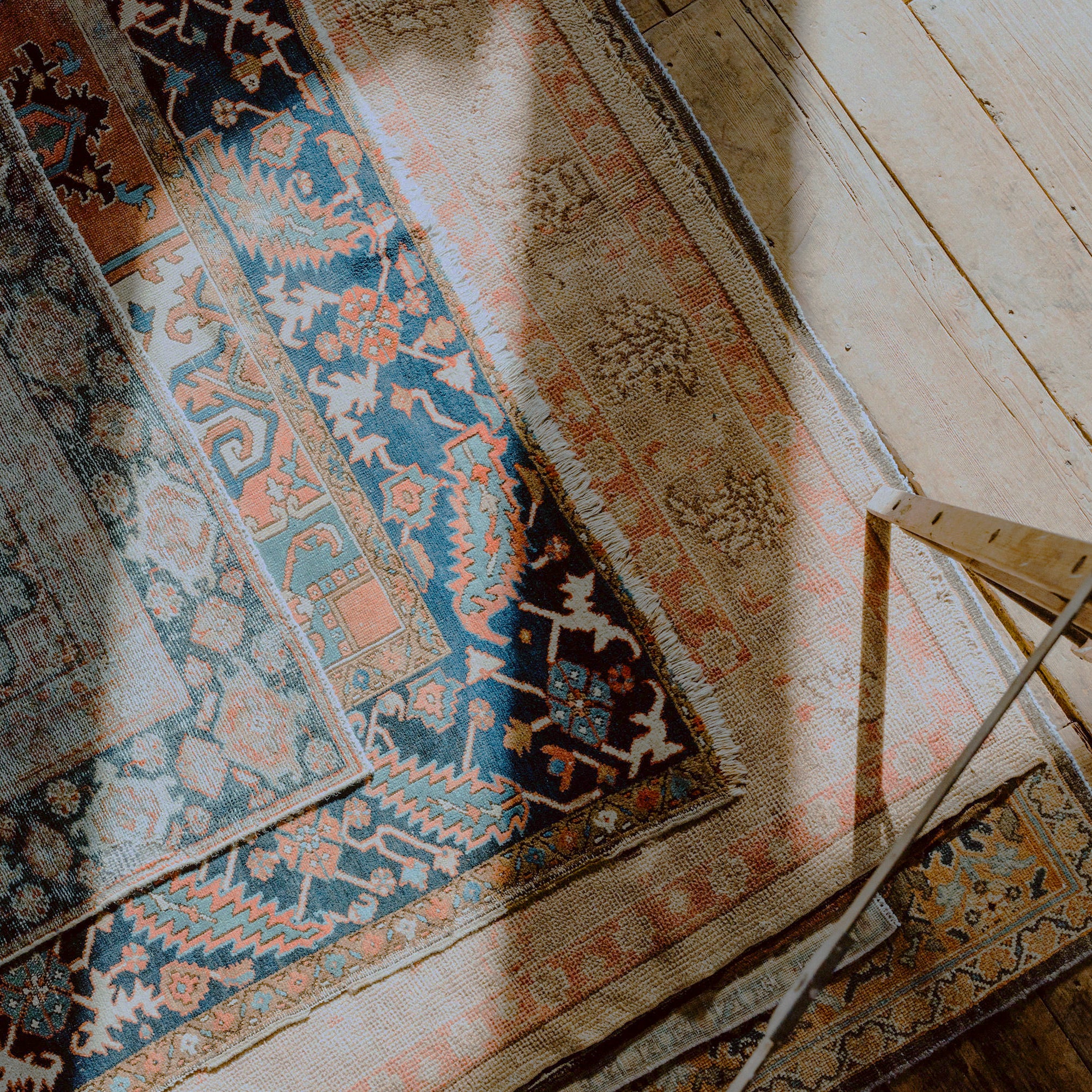 Patterned antique rug on a wooden floor