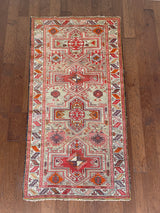 an antique caucasian shirwan rug with a silver lilac field and bright pink accents