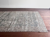 a large antique tabriz rug with a blue green field and subtle floral details