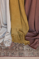 Fringed cashmere throw in Ocre