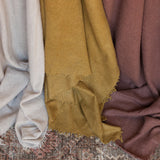 Fringed cashmere throw in Sand