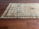 a vintage malayer rug with a teal field and detailed deer motifs 