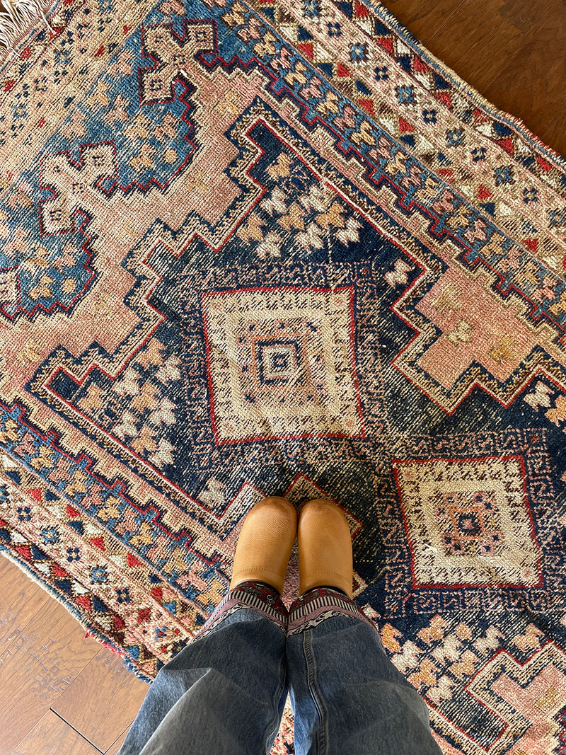 an antique-afshar-rug-with pink and blue details and two cream central medallions