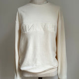 a comfy easy to wear sweatshirt in cream ivory with 'vintage' embroidered upside down for an abstract look