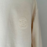 a comfy easy to wear sweatshirt in cream ivory with 'vintage' embroidered upside down for an abstract look