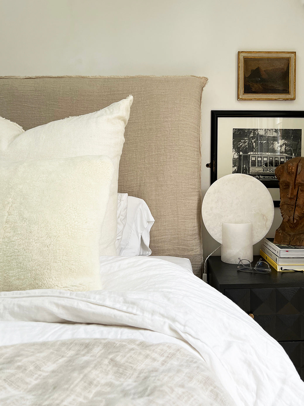 a white shearling pillow backed in plush velvet, with an exposed brass zipper
