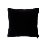 a black velvet pillow in shearling with a plush velvet backing and exposed brass zipper