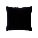 a black velvet pillow in shearling with a plush velvet backing and exposed brass zipper