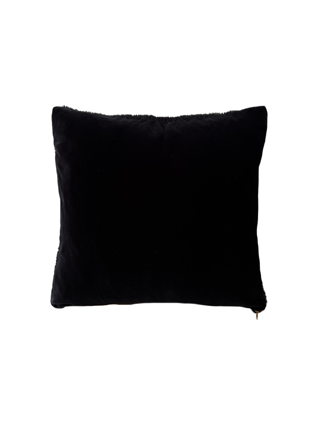 a black velvet pillow in shearling with a plush velvet backing and exposed brass zipper