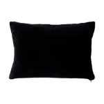 a black shearling lumbar with a plush velvet backing and exposed brass zipper