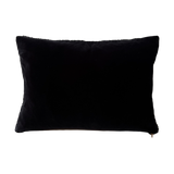 a black shearling lumbar with a plush velvet backing and exposed brass zipper