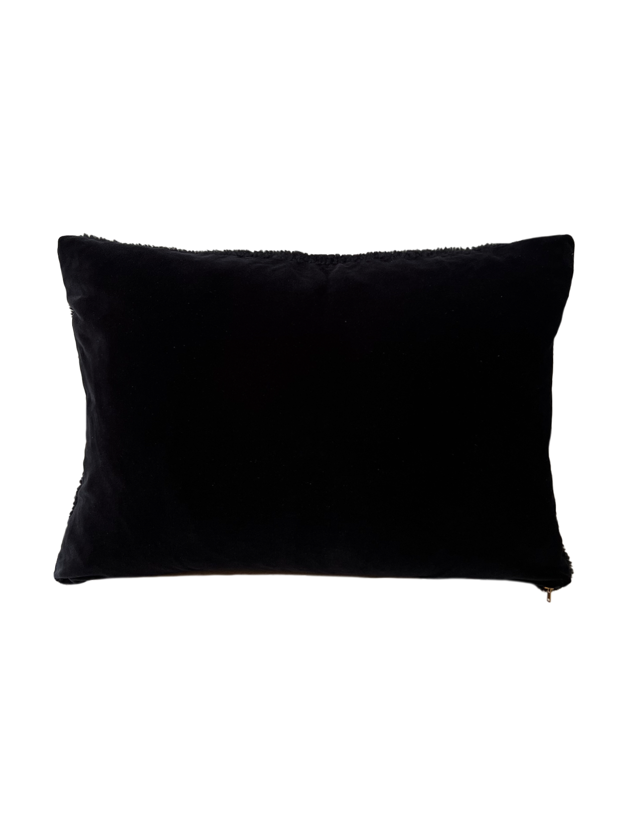 a black shearling lumbar with a plush velvet backing and exposed brass zipper