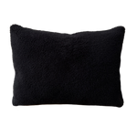 a black shearling lumbar with a plush velvet backing and exposed brass zipper