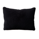 a black shearling lumbar with a plush velvet backing and exposed brass zipper