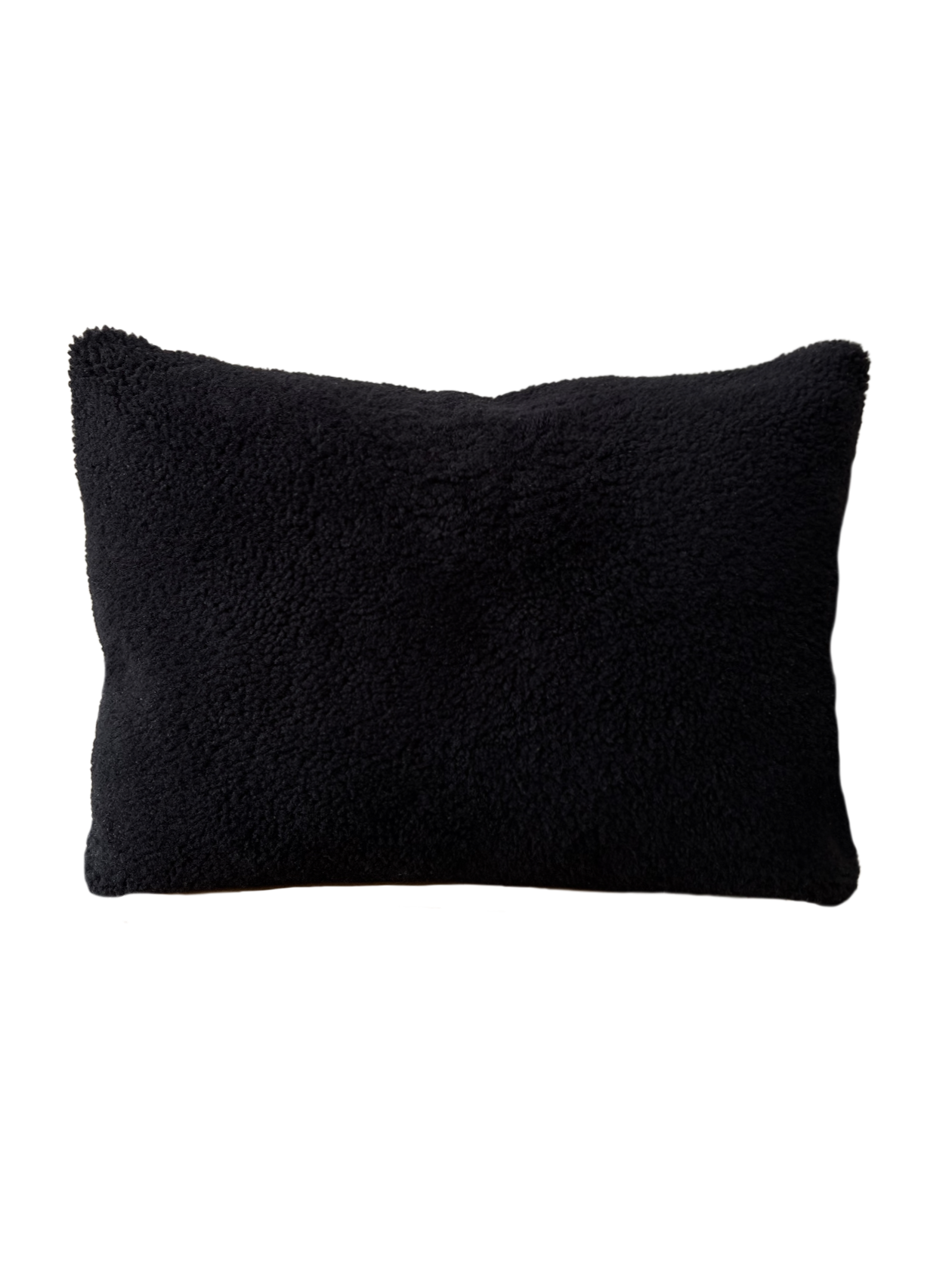 a black shearling lumbar with a plush velvet backing and exposed brass zipper