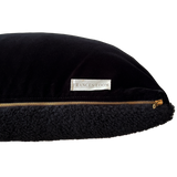 a black shearling lumbar with a plush velvet backing and exposed brass zipper