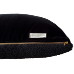 a black velvet pillow in shearling with a plush velvet backing and exposed brass zipper