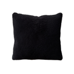 a black velvet pillow in shearling with a plush velvet backing and exposed brass zipper