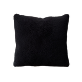 a black velvet pillow in shearling with a plush velvet backing and exposed brass zipper