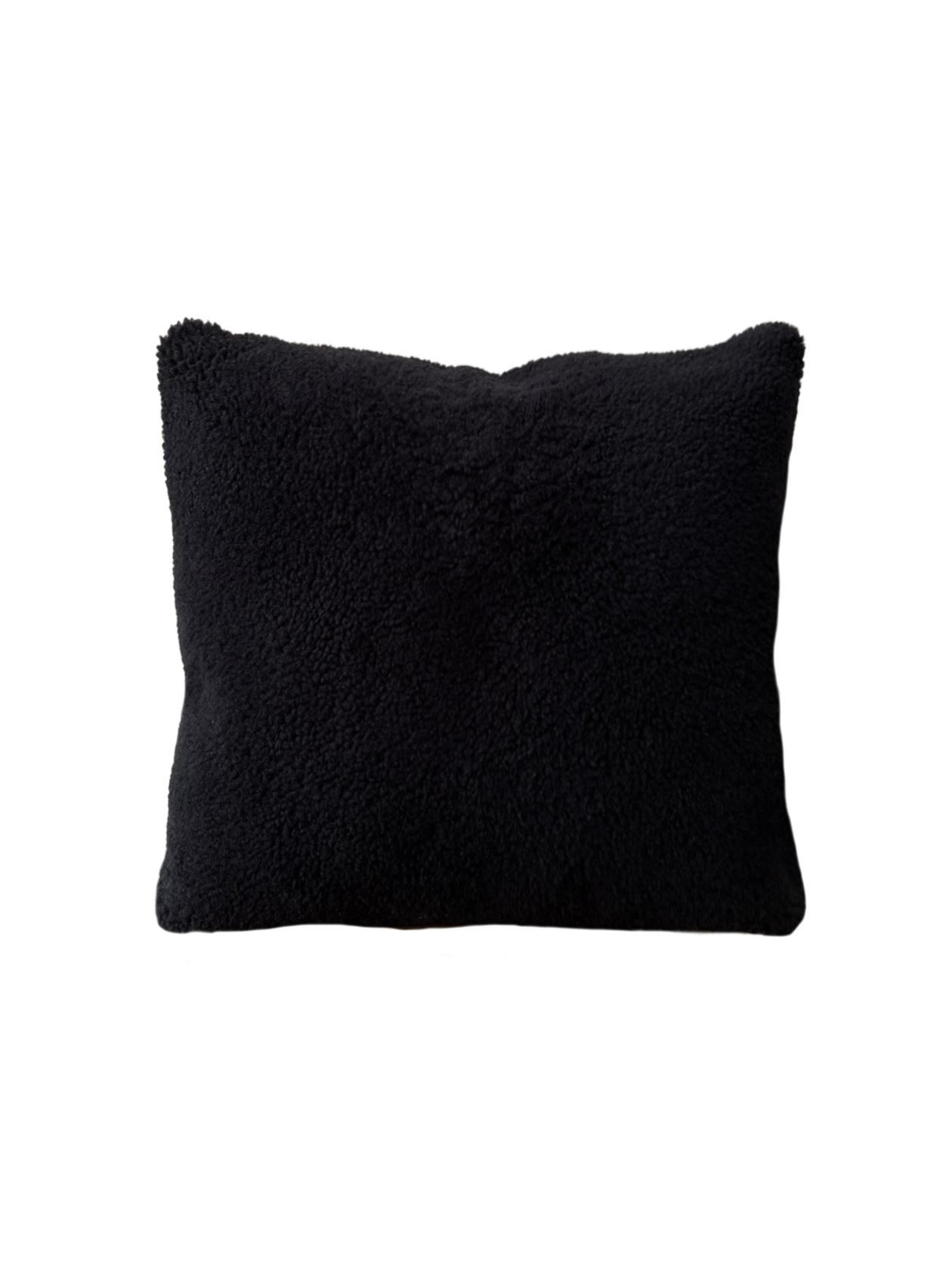 a black velvet pillow in shearling with a plush velvet backing and exposed brass zipper