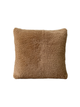 a shearling pillow in camel colored velvet with a plush velvet backing and exposed brass zipper