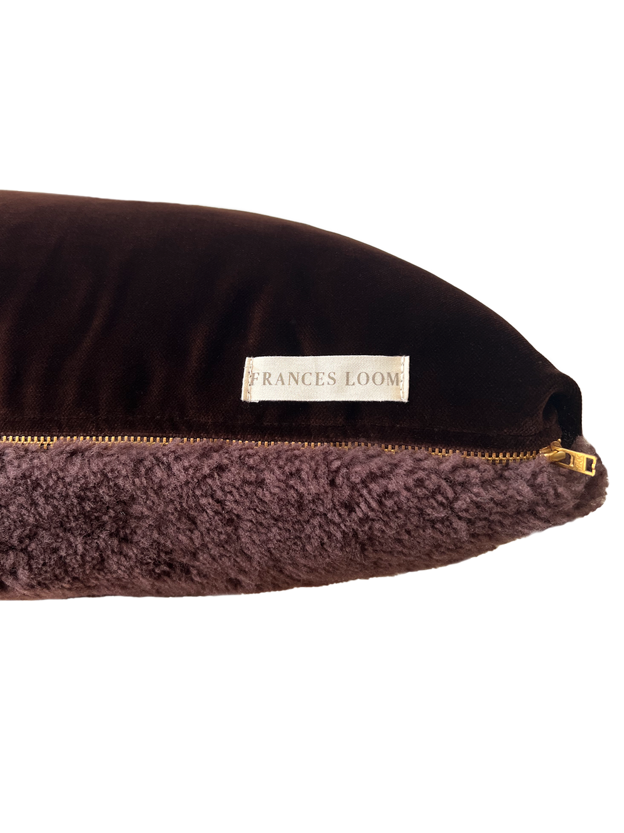 a square shearling pillow in chocolate brown shearling and plush velvet, with an exposed brass zipper