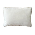 a cream lumbar pillow in shearling, backed with plush velvet