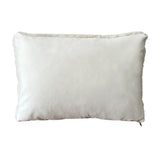 a cream lumbar pillow in shearling, backed with plush velvet