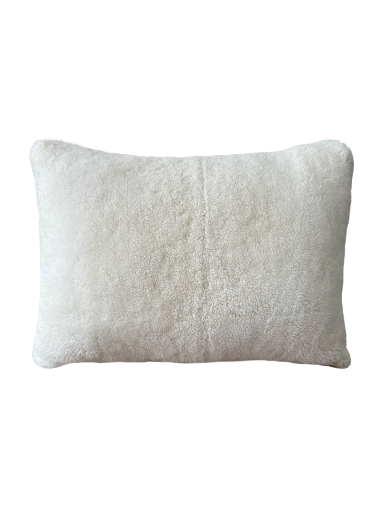 a cream lumbar pillow in white shearling
