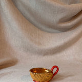 Vintage gilt cup with coral handle