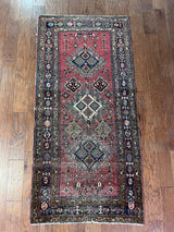 an antique heriz rug with a raspberry pink field and three pretty central medallions