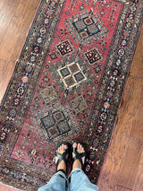 an antique heriz rug with a raspberry pink field and three pretty central medallions