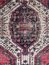 an antique hamadan rug with a pink and midnight blue palette with ivory details