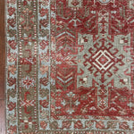 an antique heriz karajah runner with a dark coral field and icy blue and teal accents