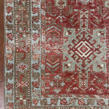 an antique heriz karajah runner with a dark coral field and icy blue and teal accents