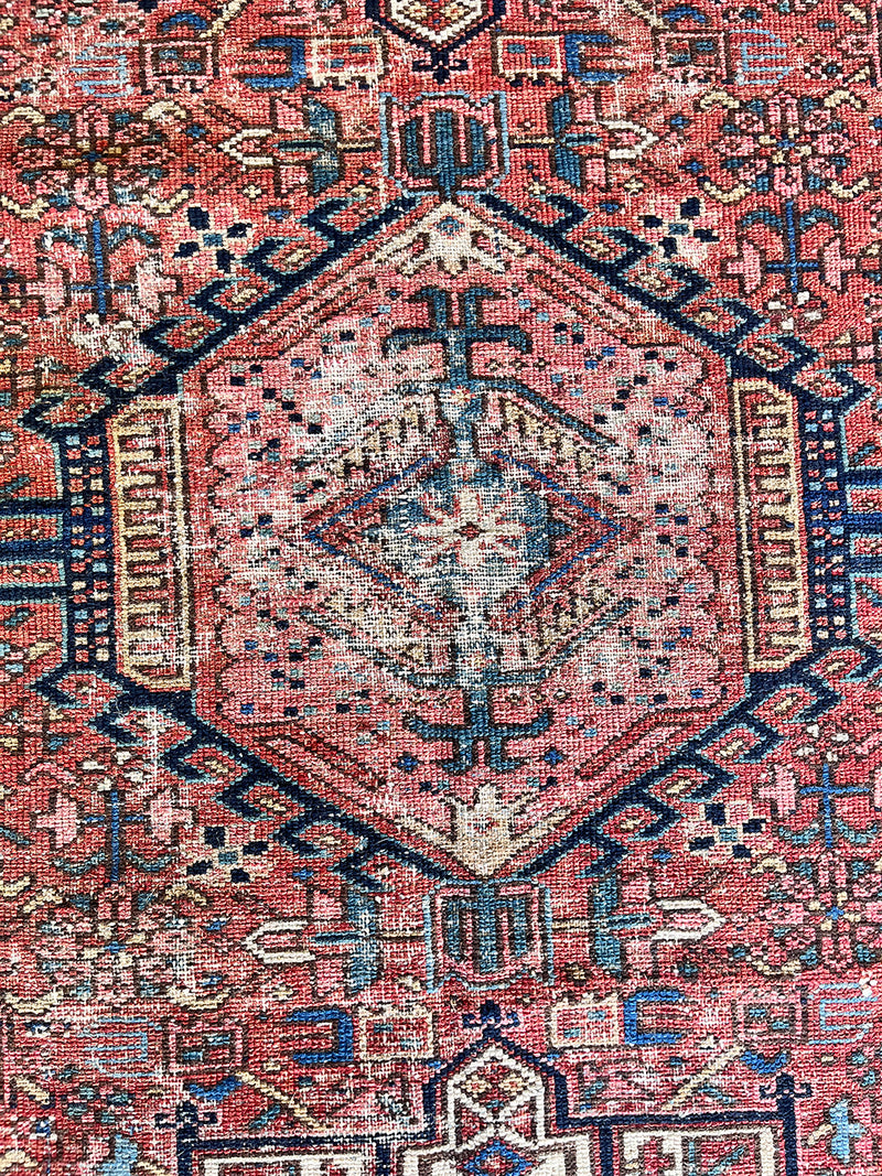 an antique pair of heriz karajah rugs with pink fields and dark blue borders