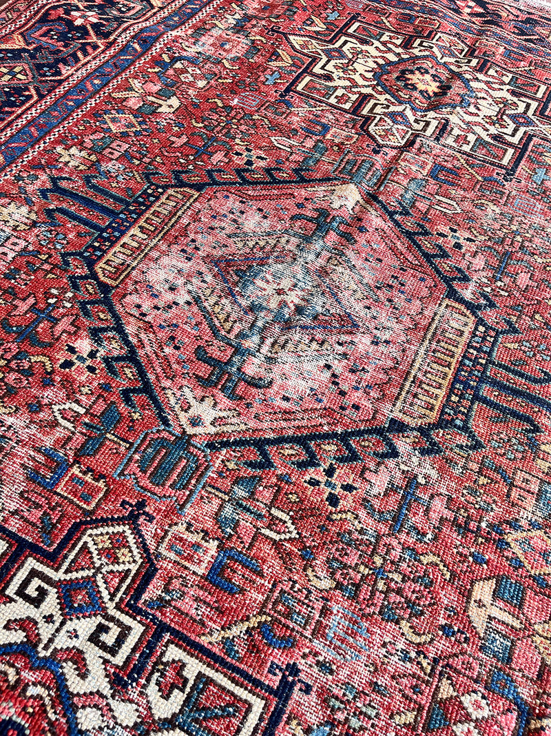 an antique pair of heriz karajah rugs with pink fields and dark blue borders